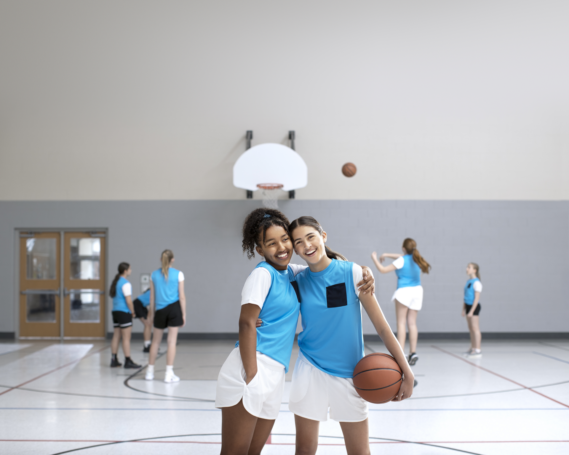 Young teen girls on basketball court